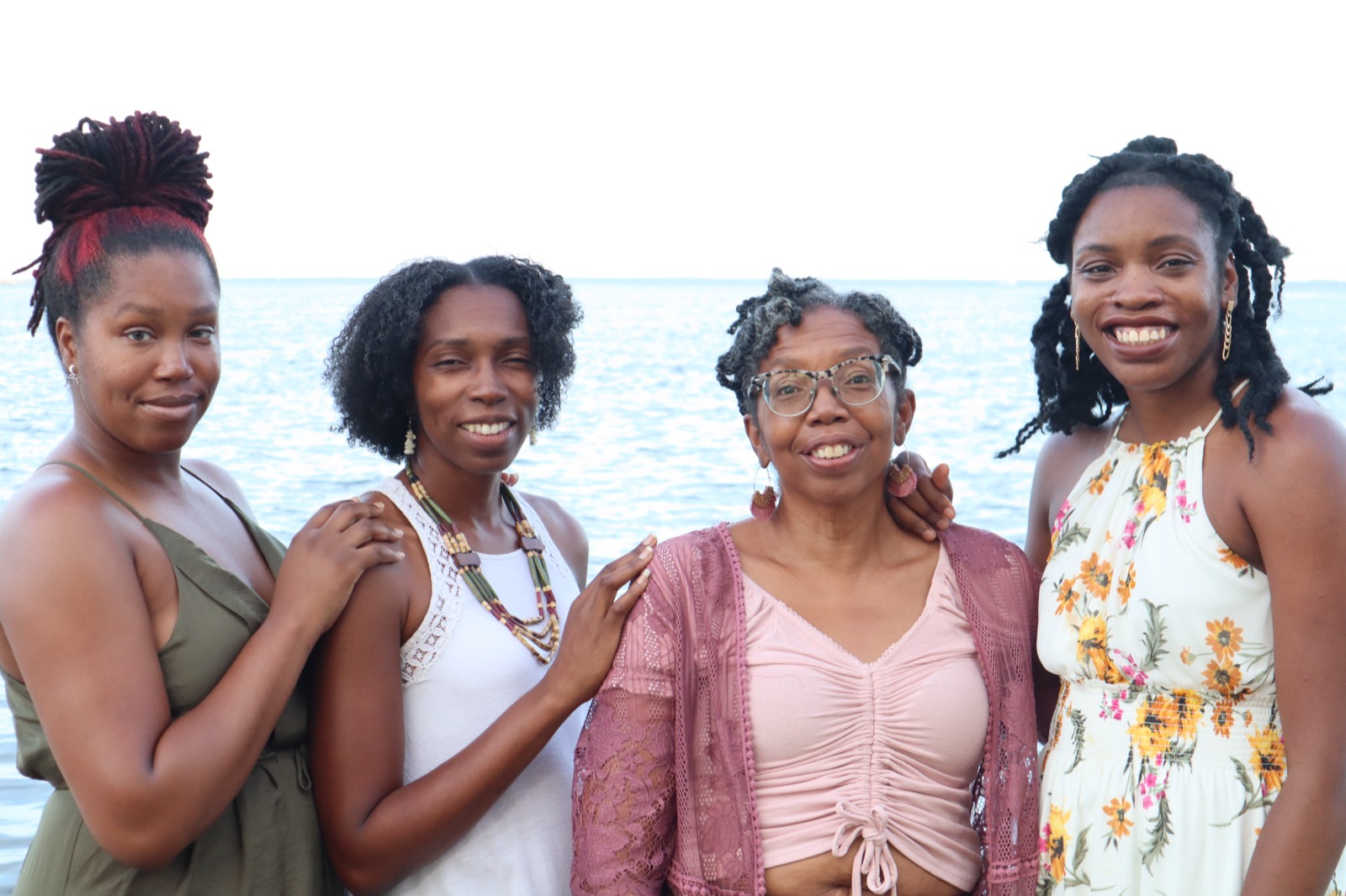 Tampa family photo session of four women by the water at sunset